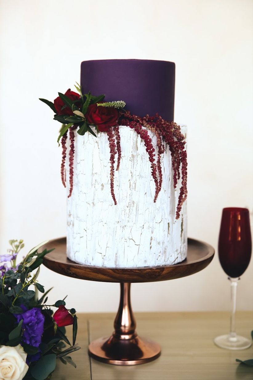 ultra violet purple and white buttercream wedding cake decorated with flowers