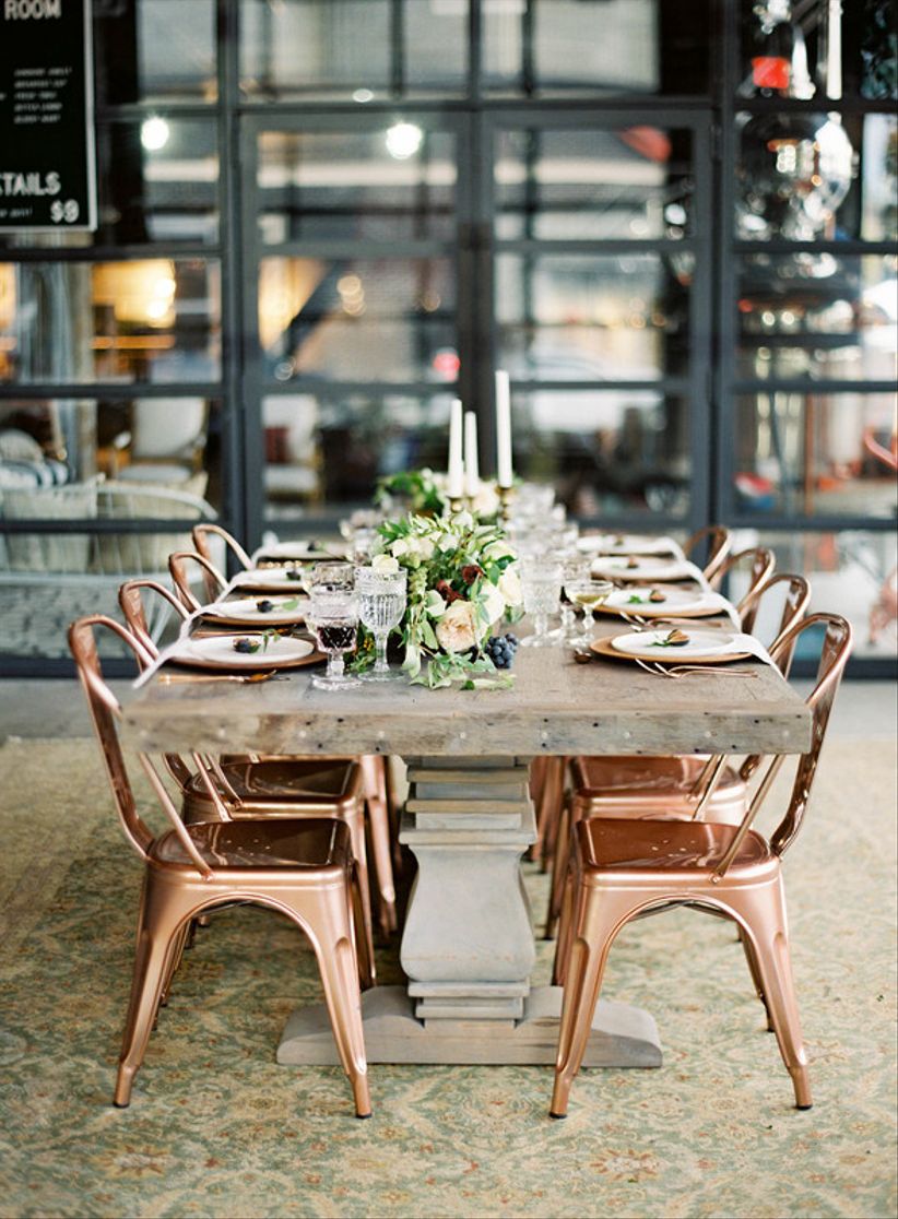 mid century modern wedding reception table with copper marais chairs and low centerpieces